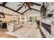 Spacious living room with a fireplace flows into the open kitchen for easy entertaining at 8280 Bannock Dr, Larkspur, CO 80118