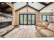 The living room's large glass doors lead to a deck, creating a seamless transition to the outdoors at 8280 Bannock Dr, Larkspur, CO 80118