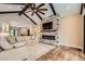 Open living room with stone fireplace, high ceilings, and a ceiling fan offers a cozy space at 8280 Bannock Dr, Larkspur, CO 80118