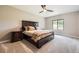 Comfortable main bedroom featuring a ceiling fan, plush carpet, and a window that provides plenty of natural light at 8280 Bannock Dr, Larkspur, CO 80118