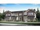 Beautiful new townhome with mixed siding, stone accents, covered porch and professional landscaping at 722 N Bently St, Watkins, CO 80137