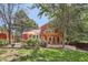 Backyard features a patio pergola with comfortable seating and a lush, landscaped yard at 7445 Shoreham Pl, Castle Pines, CO 80108