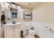Bright bathroom featuring a white vanity, framed artwork, and wainscoting at 7445 Shoreham Pl, Castle Pines, CO 80108