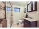 Well-lit bathroom featuring a glass-enclosed shower and modern vanity at 7445 Shoreham Pl, Castle Pines, CO 80108