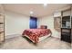 Bedroom with red floral comforter, window with curtains, and wooden cabinet at 7445 Shoreham Pl, Castle Pines, CO 80108