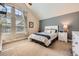 Bright bedroom with high ceilings, large windows, and neutral tones, creating a serene and inviting space at 7445 Shoreham Pl, Castle Pines, CO 80108