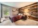 Cozy bedroom with wood accent wall, window, and neutral tones at 7445 Shoreham Pl, Castle Pines, CO 80108