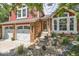 Charming two-story home with a brick entryway, two-car garage, and well-maintained landscaping at 7445 Shoreham Pl, Castle Pines, CO 80108