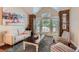 Cozy living room with vaulted ceilings, a stone accent wall, and large windows for natural light at 7445 Shoreham Pl, Castle Pines, CO 80108