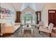 Inviting living room featuring vaulted ceilings, stone accents, and bright natural lighting at 7445 Shoreham Pl, Castle Pines, CO 80108