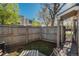 Secluded backyard with a wood fence, a small grass area, and a covered patio area for entertaining at 8745 Yukon St # 30, Arvada, CO 80005