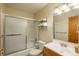 This is a clean bathroom with a shower/tub combo, a toilet, and a wood vanity with a mirror at 8745 Yukon St # 30, Arvada, CO 80005