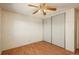 This bedroom features a ceiling fan, a closet with sliding doors, and wood-look laminate flooring at 8745 Yukon St # 30, Arvada, CO 80005