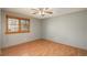 This bedroom features a large window, wood-look laminate flooring, and a ceiling fan at 8745 Yukon St # 30, Arvada, CO 80005