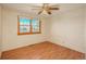Bright bedroom with natural light from a window and features a ceiling fan and wood-look laminate flooring at 8745 Yukon St # 30, Arvada, CO 80005