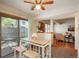 Dining area with a modern table set, a ceiling fan, and sliding glass doors offering backyard views at 8745 Yukon St # 30, Arvada, CO 80005