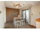 Bright dining area with a modern table set, ceiling fan, and sliding glass doors leading to the backyard at 8745 Yukon St # 30, Arvada, CO 80005