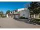 Exterior of townhomes with garages and mature trees, landscaped yards with clear blue sky at 8745 Yukon St # 30, Arvada, CO 80005