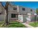 Inviting townhouse featuring a well-maintained lawn, wood siding, and a charming fenced-in front yard at 8745 Yukon St # 30, Arvada, CO 80005