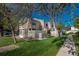 Lawn view of townhomes with manicured grass and mature trees in a well-maintained neighborhood at 8745 Yukon St # 30, Arvada, CO 80005