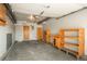 Spacious garage interior with concrete floor and built-in wooden shelving for storage at 8745 Yukon St # 30, Arvada, CO 80005