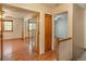 Charming hallway leads to a bedroom with hardwood floors, a sliding glass door, and a window with natural light at 8745 Yukon St # 30, Arvada, CO 80005