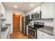 Functional kitchen with white cabinets, granite counters, and stainless steel appliances for a modern look and feel at 8745 Yukon St # 30, Arvada, CO 80005
