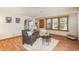 Cozy living room showcasing hardwood floors, updated windows, and an open layout for easy entertaining at 8745 Yukon St # 30, Arvada, CO 80005
