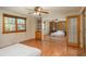 Spacious main bedroom with a window, closet with sliding doors, built-in shelves, and hardwood floors at 8745 Yukon St # 30, Arvada, CO 80005