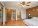 Main bedroom boasts beautiful hardwood floors and an attached bathroom, with neutral-colored walls and decor at 8745 Yukon St # 30, Arvada, CO 80005