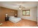 This main bedroom has an accent wall, a window, and wood-look laminate flooring with decor at 8745 Yukon St # 30, Arvada, CO 80005