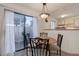 Bright dining area features sliding glass doors to a patio and adjoins the kitchen at 6380 S Boston St # 111, Greenwood Village, CO 80111