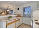 Efficient kitchen features white appliances, good counter space, and a pass-through bar to living space at 6380 S Boston St # 111, Greenwood Village, CO 80111