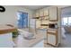 Efficient kitchen features white appliances, good counter space, and a pass-through bar to living space at 6380 S Boston St # 111, Greenwood Village, CO 80111