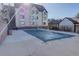 Community pool with cover surrounded by concrete with a residential building in the background at 6380 S Boston St # 111, Greenwood Village, CO 80111