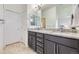 Bathroom showcasing double sinks with granite countertops and modern fixtures at 10117 Morrison Rd, Lakewood, CO 80227