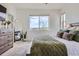 Comfortable bedroom with soft textures, large windows, and mountain views at 10117 Morrison Rd, Lakewood, CO 80227
