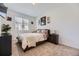 Comfortable bedroom with a dresser, side tables, and neutral color scheme at 10117 Morrison Rd, Lakewood, CO 80227