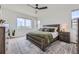 Bright main bedroom featuring a large window with mountain views, plush rug, and minimalist decor at 10117 Morrison Rd, Lakewood, CO 80227