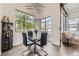 Contemporary dining area featuring a glass-top table, stylish lighting, and large windows offering scenic views at 10117 Morrison Rd, Lakewood, CO 80227