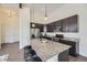 Well-appointed kitchen with a large island, granite countertops, modern lighting, and stainless steel appliances at 10117 Morrison Rd, Lakewood, CO 80227