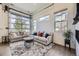 Cozy living room with a unique garage door-style window, plush seating, and a textured rug, perfect for relaxation at 10117 Morrison Rd, Lakewood, CO 80227