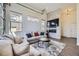 Stylish living room featuring a modern fireplace, comfortable seating, and plenty of natural light from large windows at 10117 Morrison Rd, Lakewood, CO 80227