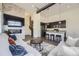 Open-concept living room and kitchen with a modern fireplace, comfortable seating, and a sleek kitchen island with seating at 10117 Morrison Rd, Lakewood, CO 80227