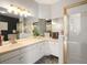 Bathroom features a vanity with tile countertop, ample lighting, and enclosed shower with glass door at 10105 Grove Loop # D, Westminster, CO 80031