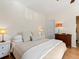 Relaxing bedroom featuring warm lighting, comfortable bed, and classic wooden dresser at 10105 Grove Loop # D, Westminster, CO 80031