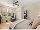 Bedroom featuring a comfortable chair, large window, and ceiling fan with light at 10105 Grove Loop # D, Westminster, CO 80031