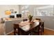 Dining area with a rustic wooden table, seamlessly connected to living room and kitchen at 10105 Grove Loop # D, Westminster, CO 80031