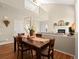 Dining area with a rustic wooden table, seamlessly connected to living room and kitchen at 10105 Grove Loop # D, Westminster, CO 80031