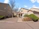 Attractive townhome with a manicured lawn, lush trees, and stone accents adding character to the facade at 10105 Grove Loop # D, Westminster, CO 80031